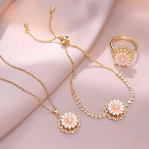 Detailed jewelry set view featuring rotating pink daisy necklace and bracelet on pink silk