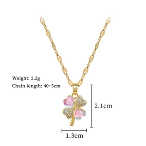 Detail of clover pendant with pink heart gems and small diamonds on a gold chain