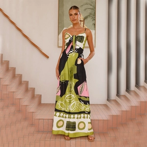 Detail of tropical print jumpsuit featuring a deep V-neck and front tie on fluid fabric