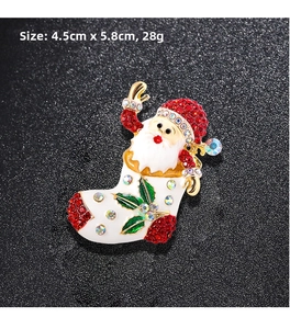 Detail view of Santa Claus brooch showing 4.5cm x 5.8cm size with red rhinestones