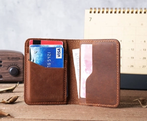Detail view of the brown crazy horse leather wallet interior showing card slots and stitching