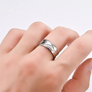 Mens silver ring with geometric striped engravings and polished finish on middle finger