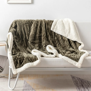 Detail of olive green striped flannel blanket with thick white sherpa fleece lining
