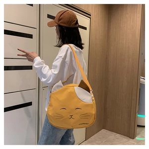 Detail of cute yellow cat canvas bag featuring adjustable strap and patchwork design