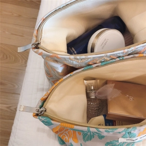 Floral makeup bags with metal zipper and large opening showing beige interior lining