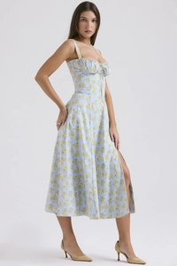 Detail of light blue floral summer midi dress featuring a side slit and slim straps