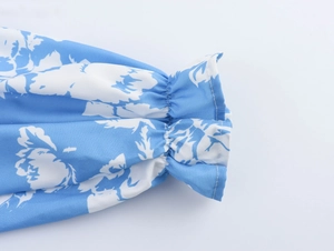 Detail eines blumigen Kleiderärmels mit elastischen Rüschenbündchen und Stoffstruktur