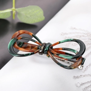 French bow hair clip with tortoiseshell pattern and silver metal spring base