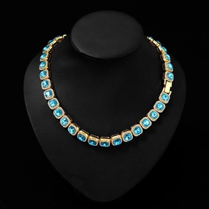 Close-up of hip-hop chain with lake blue ice square stones and pavé crystals on a black bust