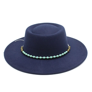 Navy blue flat top wool hat with turquoise beaded band and wide brim for women