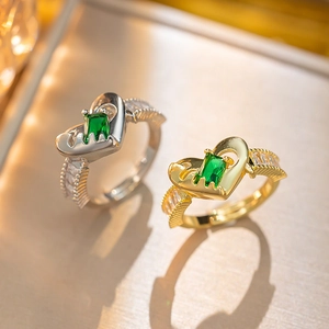 Gold and silver heart rings with green rectangular zircon stones and hollow details