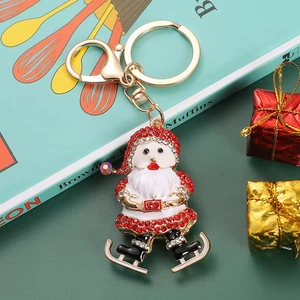 Sparkly Santa Claus keychain with red rhinestones and 925 stamp on festive background