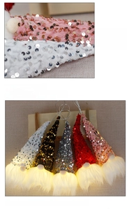 Detail of sequined Christmas gnome light with soft white beard and hanging rope for decor
