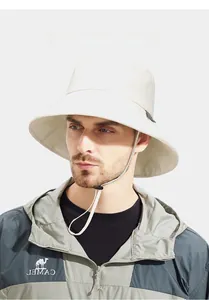 Detail of a beige wide brim sun hat with adjustable chin strap for outdoor activities