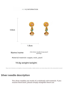 Detail shot of vintage style pearl drop earrings with 925 silver needles and gold relief