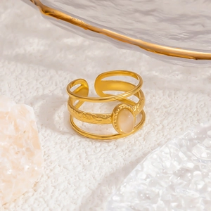 Detail of 18k gold layered open ring featuring an oval opal stone and crystal decor
