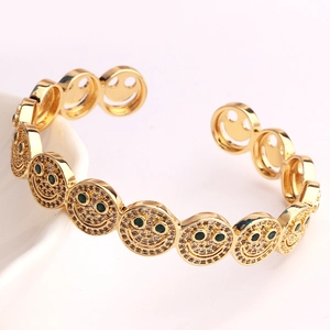 Vintage golden smiley face open cuff bracelet with green eyes and white rhinestones