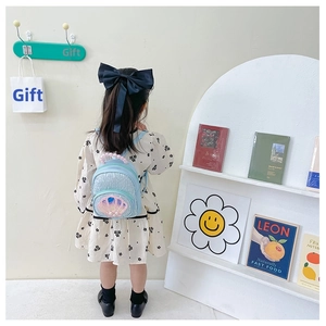 Blue sequin toddler backpack with pearl handle and shell detail worn by a girl