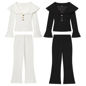 Elegant two-piece set with lapel top and flare pants featuring gold buttons in black and white