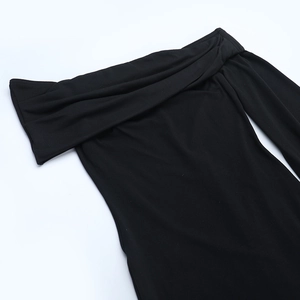 Detail view of the black off-shoulder neckline and ribbed texture of the bodycon dress