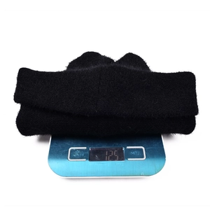 Weight measurement of 125g for the black plush rabbit ear beanie hat on a scale