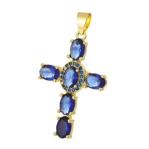 Close-up of gold-plated cross pendant with blue zircon gems and tiny blue crystals