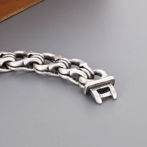 Close-up of vintage silver interlocking handcuff buckle on heavy punk metal bracelet