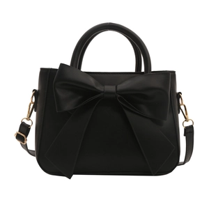 Elegant black PU leather handbag with large decorative bow and golden hardware on white background