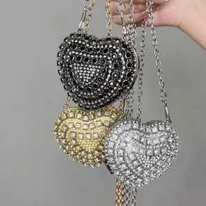 Detailed view of heart-shaped rhinestone evening bags in black, gold and silver finishes