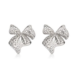 Vintage silver hollow bow earrings with detailed grid pattern and mirrored reflection