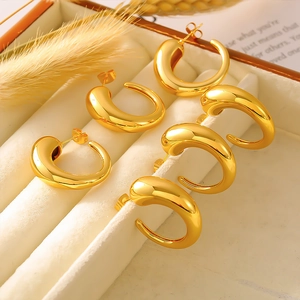 Set of 3 pairs golden C-shape hollow hoop earrings displayed in a beige jewelry box