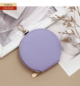 Close-up of purple litchi texture coin purse with golden zipper and lobster clasp hook
