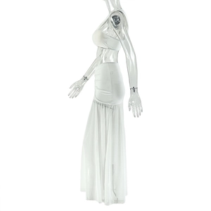 Side view of white two-piece holiday set featuring a tube top and split maxi skirt
