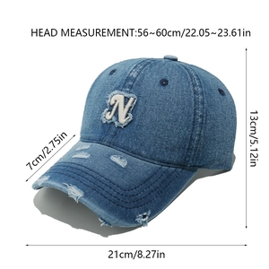 Macro detail of distressed denim baseball cap with white 3D letter N embroidery