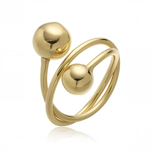 Detailed view of glossy gold spiral ring with double ball design and high mirror polish