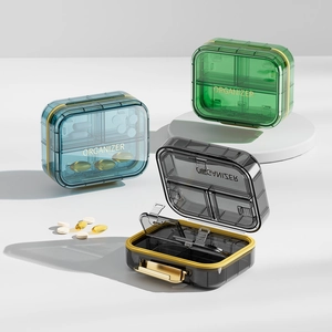 Portable 4-compartment weekly pill organizer in blue, green, and black matte finish