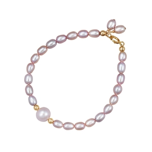 Detail view of purple freshwater pearl bracelet with gold beads and lobster clasp