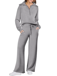 Detail of grey knitted two-piece set featuring half-zip collar and wide-leg drawstring pants