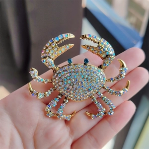 Macro detail of luxury crab brooch with colorful rhinestones and gold-plated finish