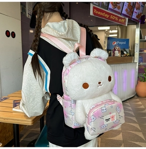 Detail showing plush white bunny backpack with pink straps and printed front pocket