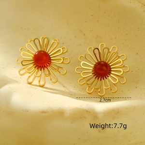 Detailed view of a gold floral stud earring with a red bead and dimension markings