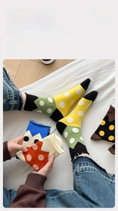 Close-up of vibrant polka dot and geometric pattern cotton crew socks for women