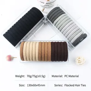 Three-pack set of flocking hair elastics in black, grey, and brown with storage boxes