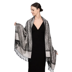 Detail of silver grey paisley shawl featuring elegant black tassel fringe on the edges