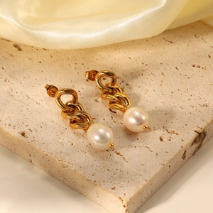 Detailed shot of 18K gold plated Cuban chain earrings with baroque freshwater pearls