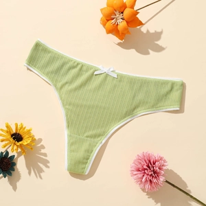 Breathable light green ribbed thong for women with a delicate white bow detail