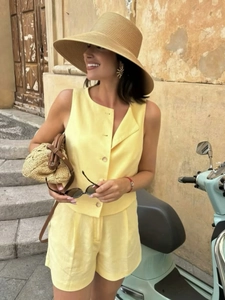 Conjunto de chaleco amarillo sin mangas y pantalones cortos con accesorios de paja
