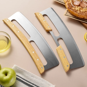 Stainless steel rocking pizza cutter with wooden handle on a kitchen counter