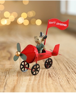 Detail of reindeer pilot in a red metal plane with a Merry Christmas flag hanging