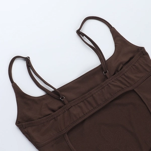 Close-up of deep brown knit bodycon dress with adjustable straps and fine ribbed texture